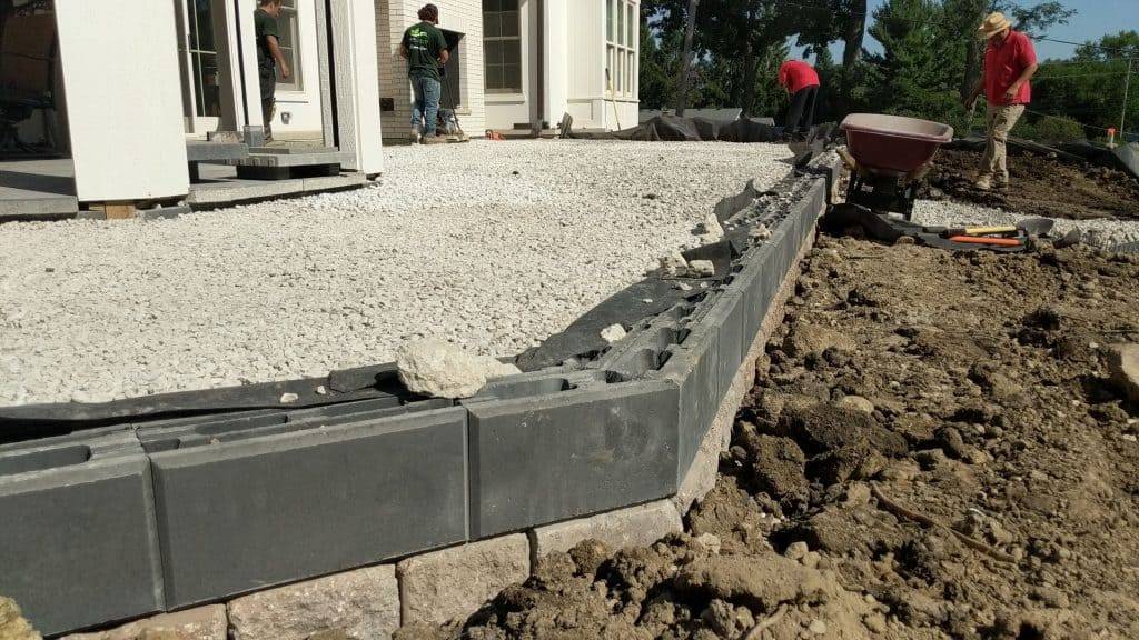 Aggregate base and edge restraint installed before pavers are laid